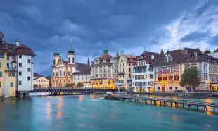 The Reuss River with surrounding buildings during a stormy evening in Lucerne, Switzerland